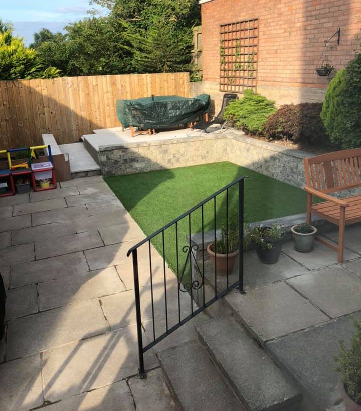 After picture of a garden with new raised patio and artifcial grass